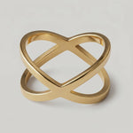 rotating video of a gold-plated ring with two slender bands that intersect creating a modern X-shape design