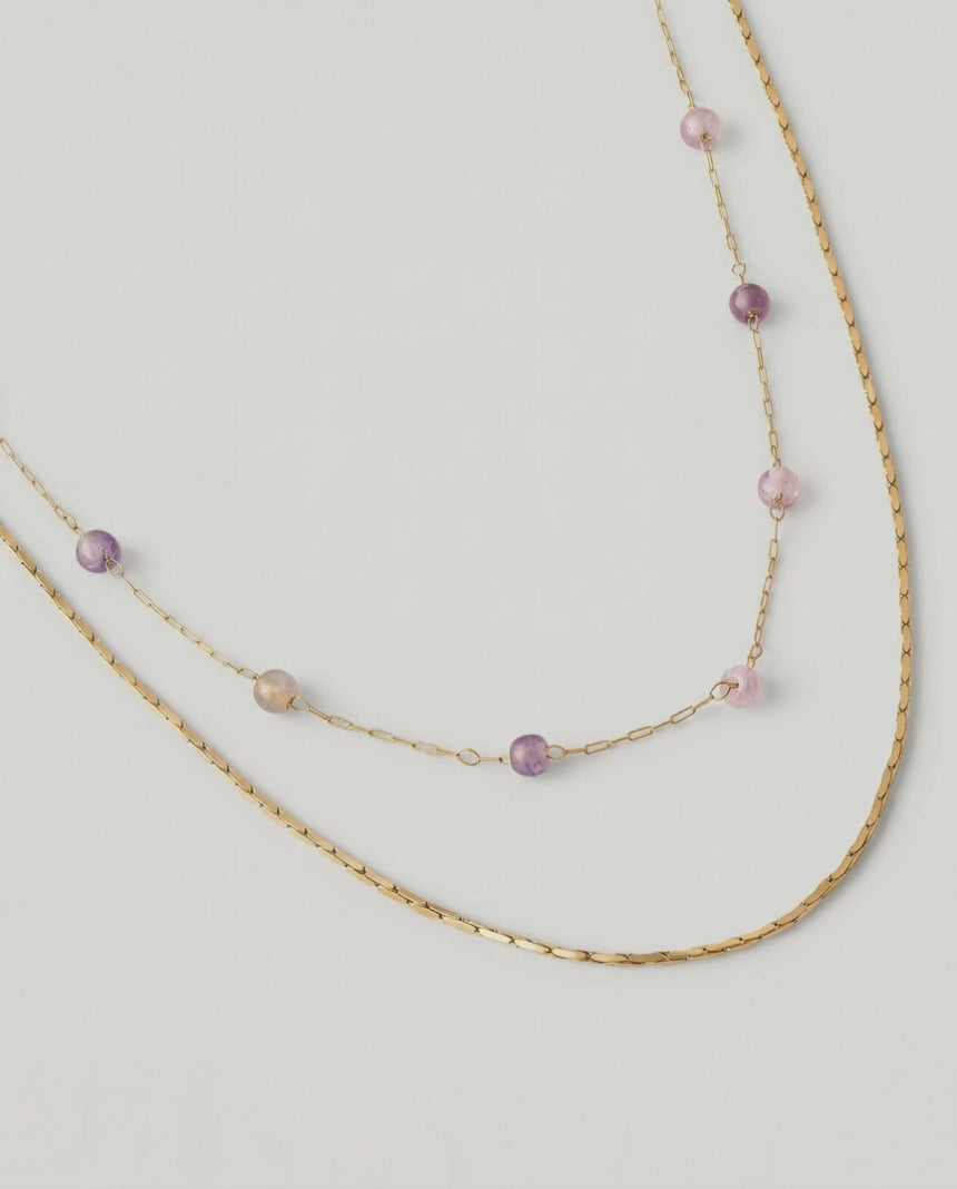 video of a two-strand gold-plated necklace with delicate rose quartz beads and a sleek snake chain.