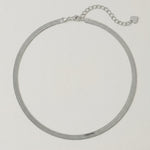 video of a sleek sterling silver herringbone chain necklace with an adjustable length and a heart charm