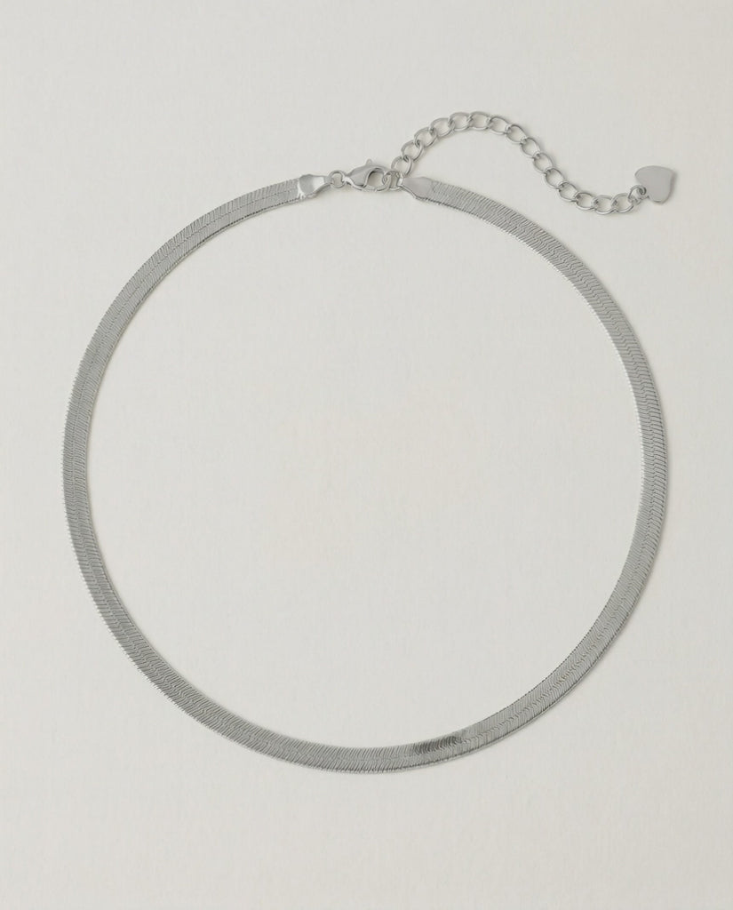 video of a sleek sterling silver herringbone chain necklace with an adjustable length and a heart charm