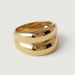 A gold-plated ring with a smooth, curved design 