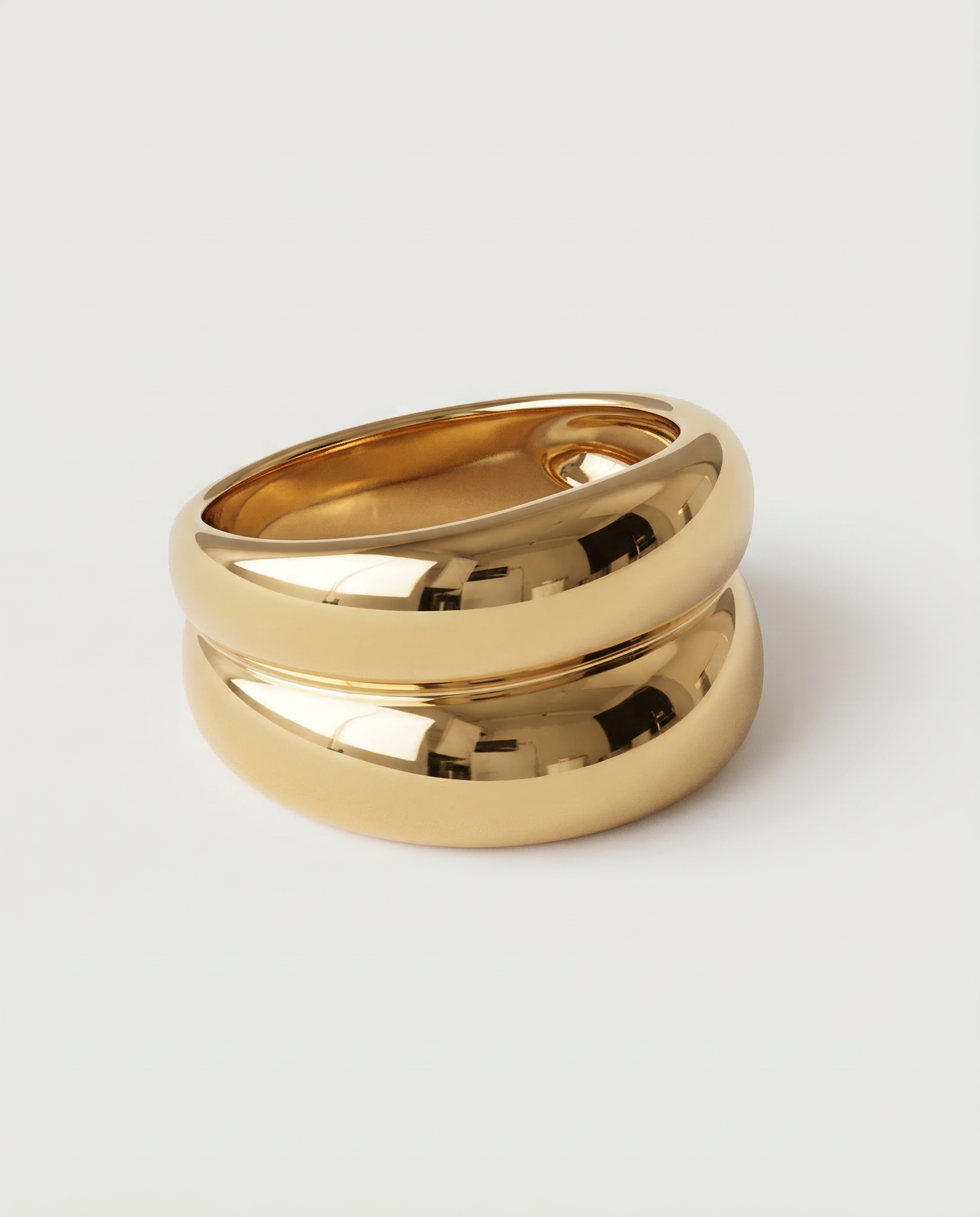 A gold-plated ring with a smooth, curved design 
