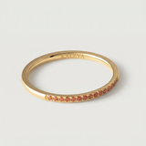 a gold-plated ring with a single row of orange crystals around its circumference.