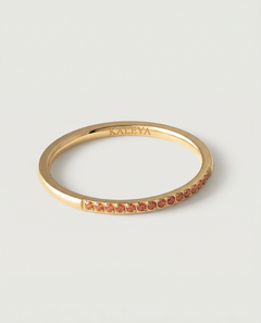 a gold-plated ring with a single row of orange crystals around its circumference.