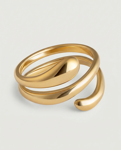 A gold-plated stainless steel ring with an architectural, coiled design, displayed against a white background.