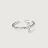 A silver ring with a delicate cross adorned with sparkling diamonds on the top, set on a slender band with pave-set diamonds.