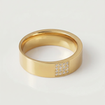 A gold-plated stainless steel ring with a polished finish and a section of the band adorned with pavé-set stones.