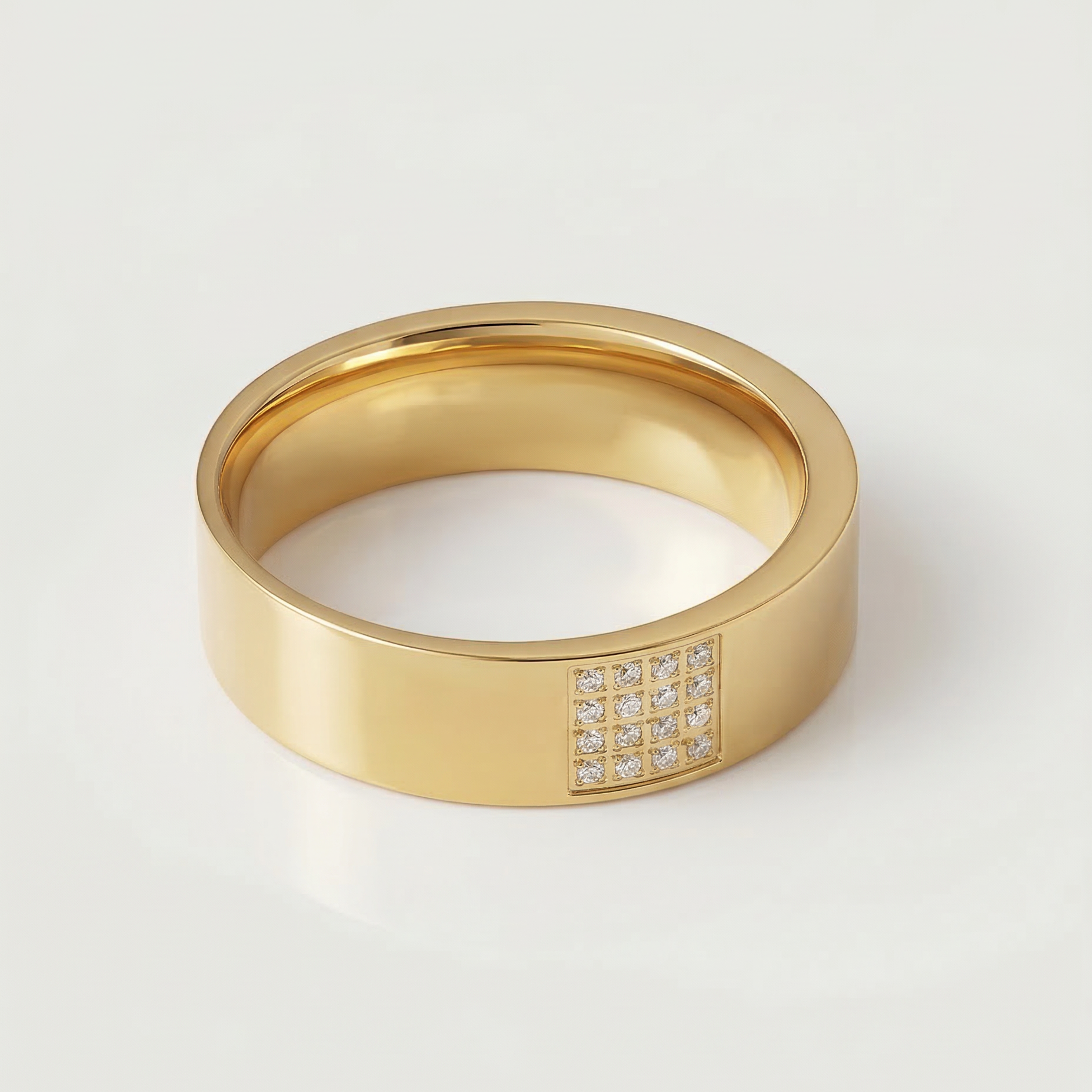 A gold-plated stainless steel ring with a polished finish and a section of the band adorned with pavé-set stones.
